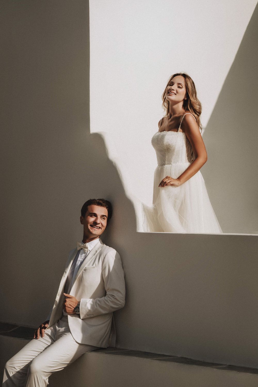 Minimalist studio photography with strong shadow play and clean white walls.