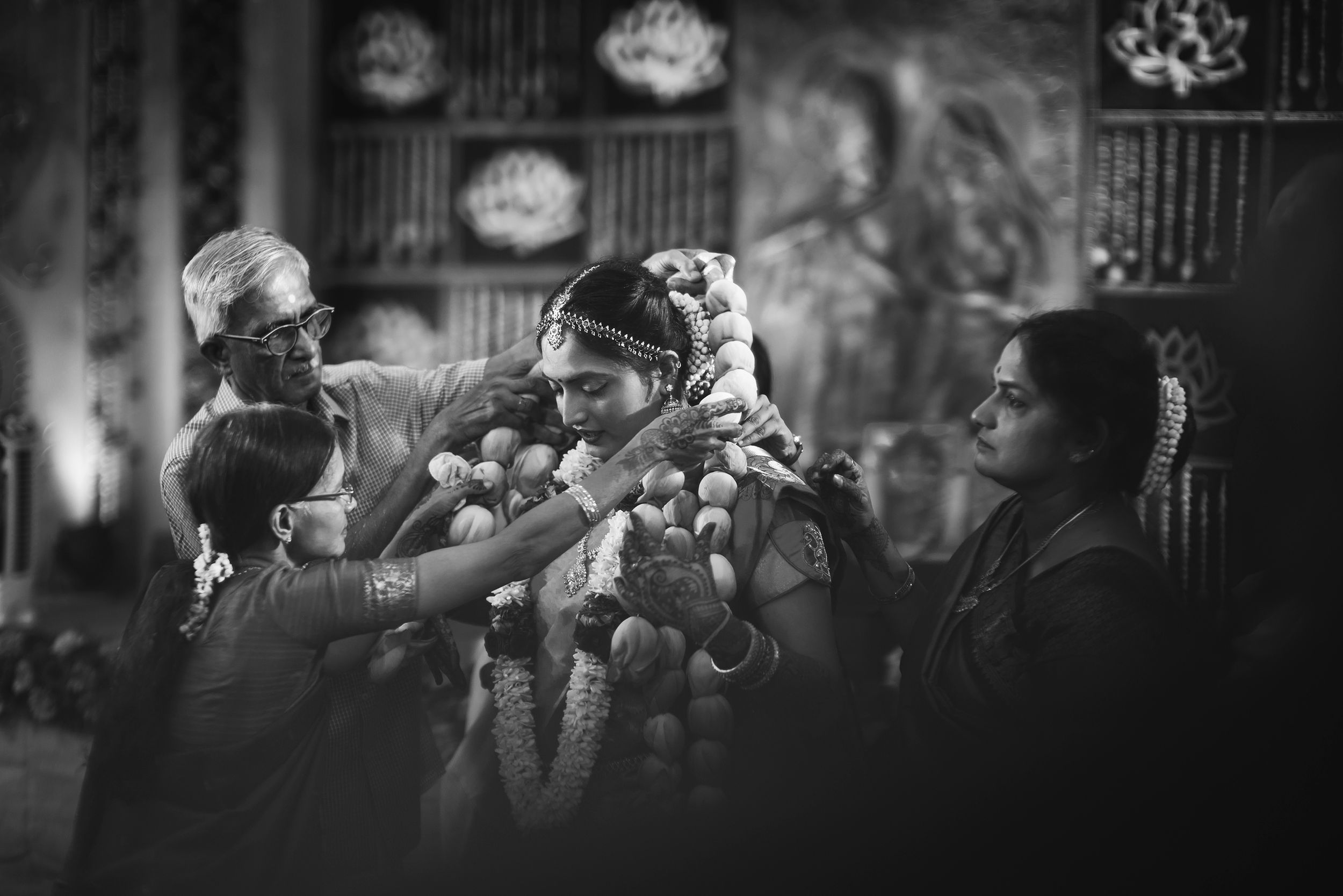 Traditional South Indian Tamil wedding ceremony with guests showering flower petals in black and white.