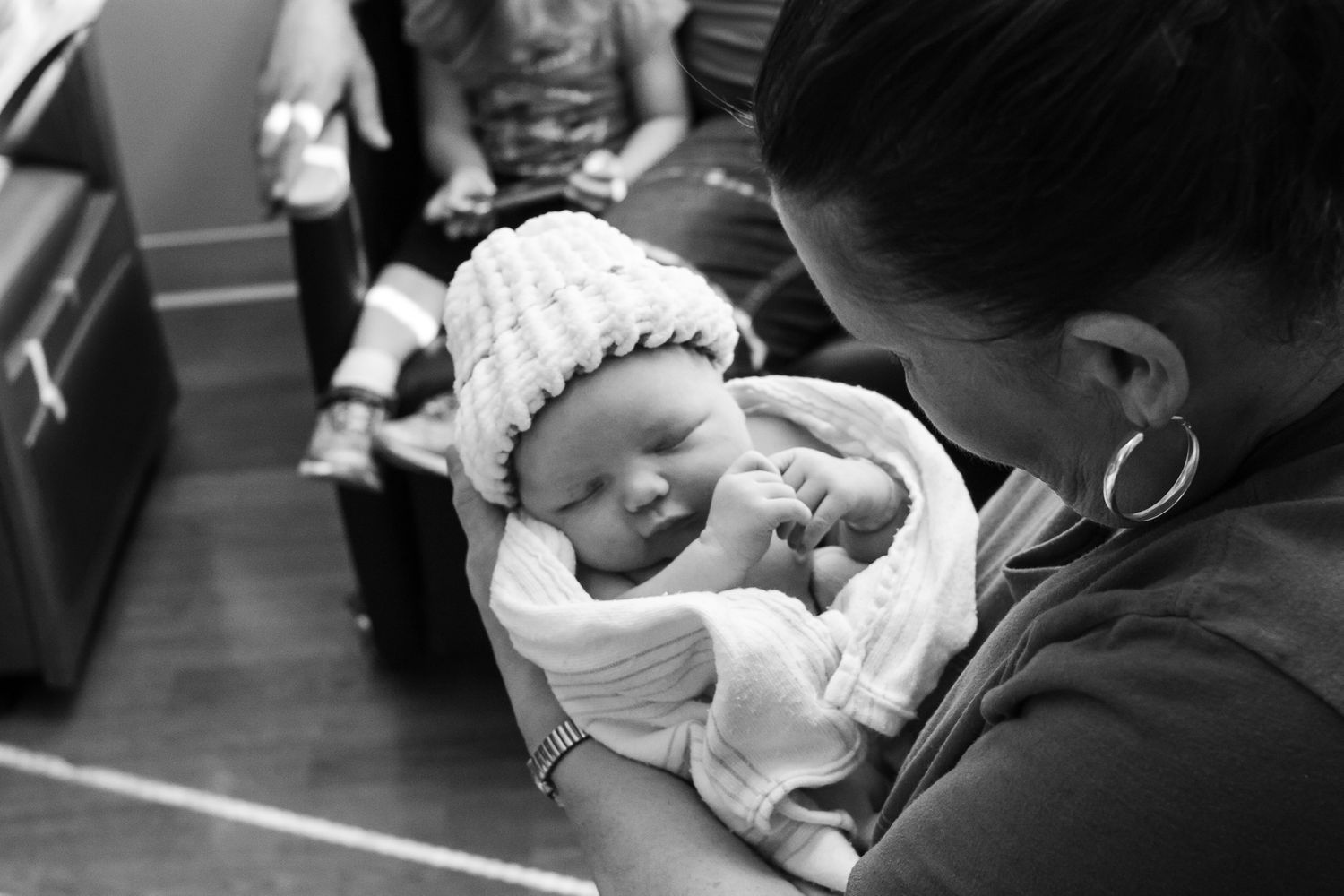 Grandmother holding her newest granddaughter just after birth.
