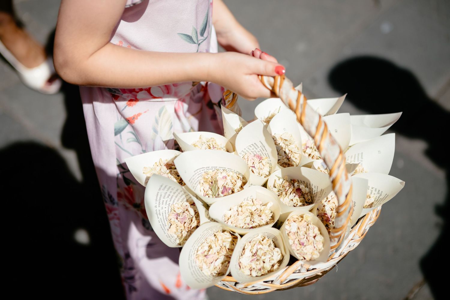 A basket of confetti is carried by a flower girl in Italy.