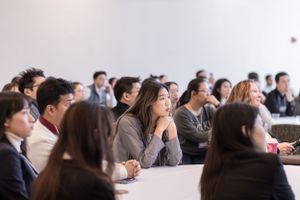 Students attend a professional communication workshop in a modern conference room setting.