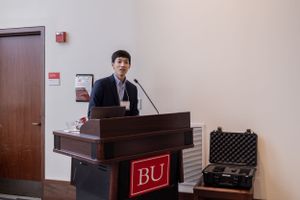 Presentation podium setup with BU branding in a professional meeting space.