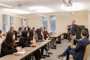 Conference room filled with attendees viewing a presentation in classroom-style seating.