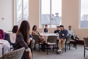 Modern conference room with large windows and rows of chairs for attendees.