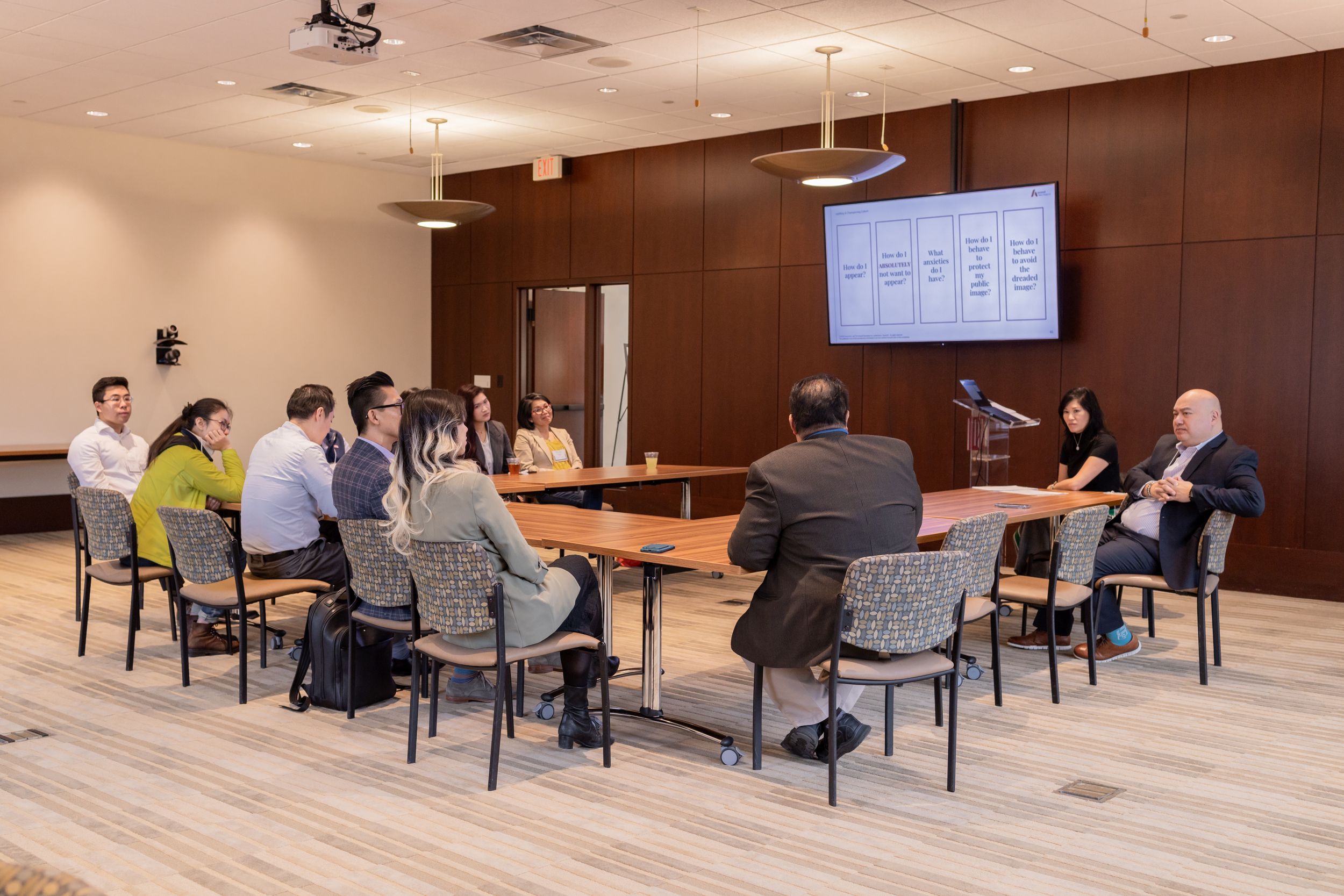 Corporate meeting space with contemporary design and multimedia presentation setup.