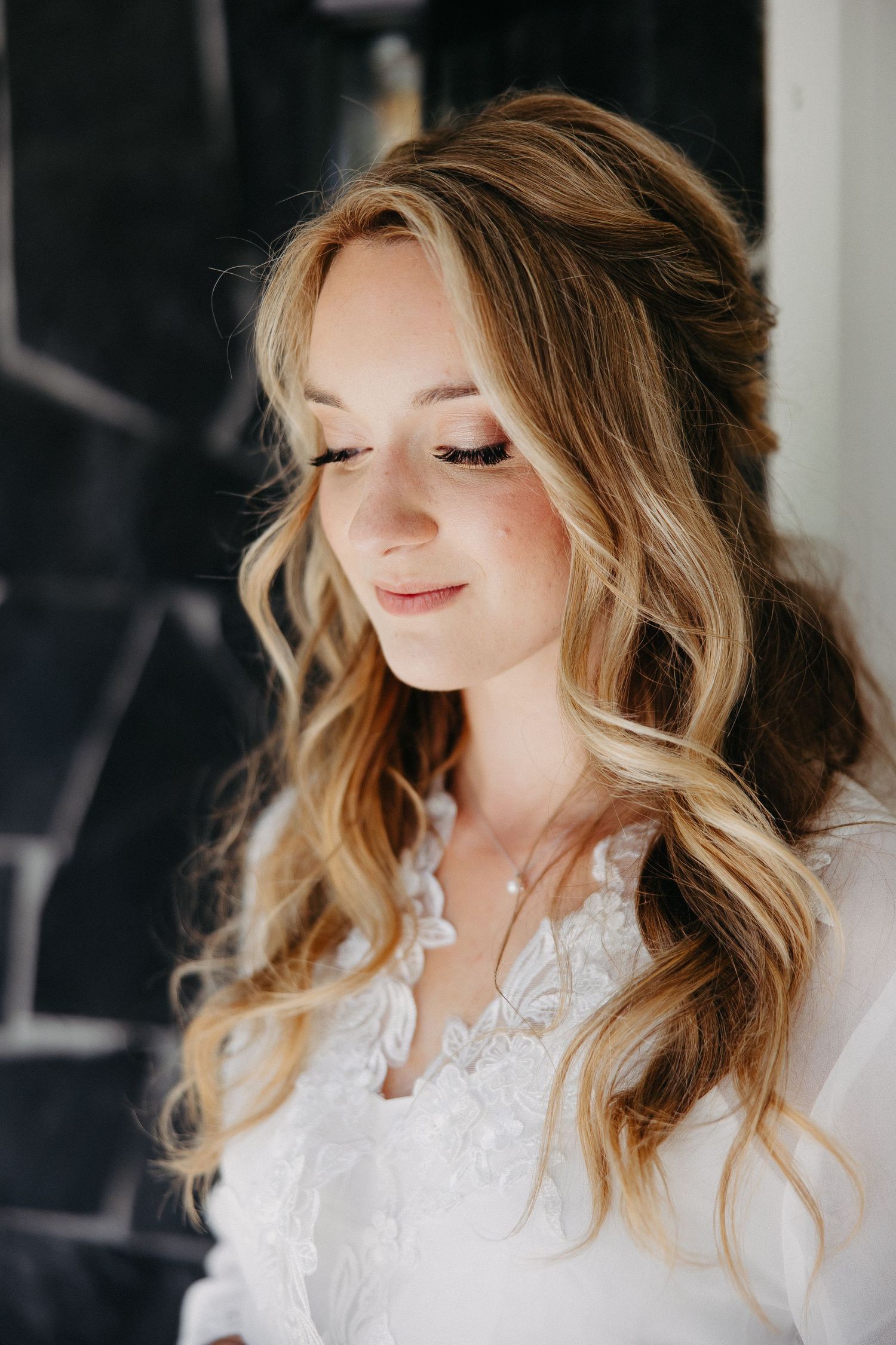 Romantic bridal beauty portrait with soft wavy hair and natural makeup.