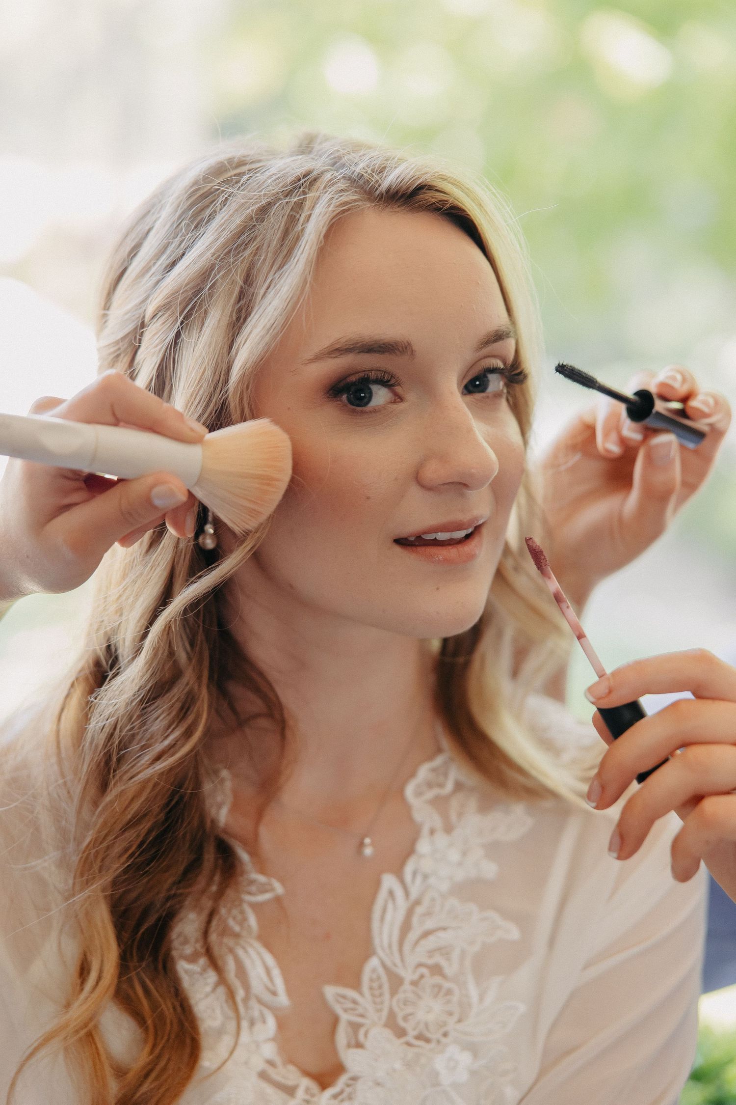 Close up of makeup application with brushes and beauty tools.