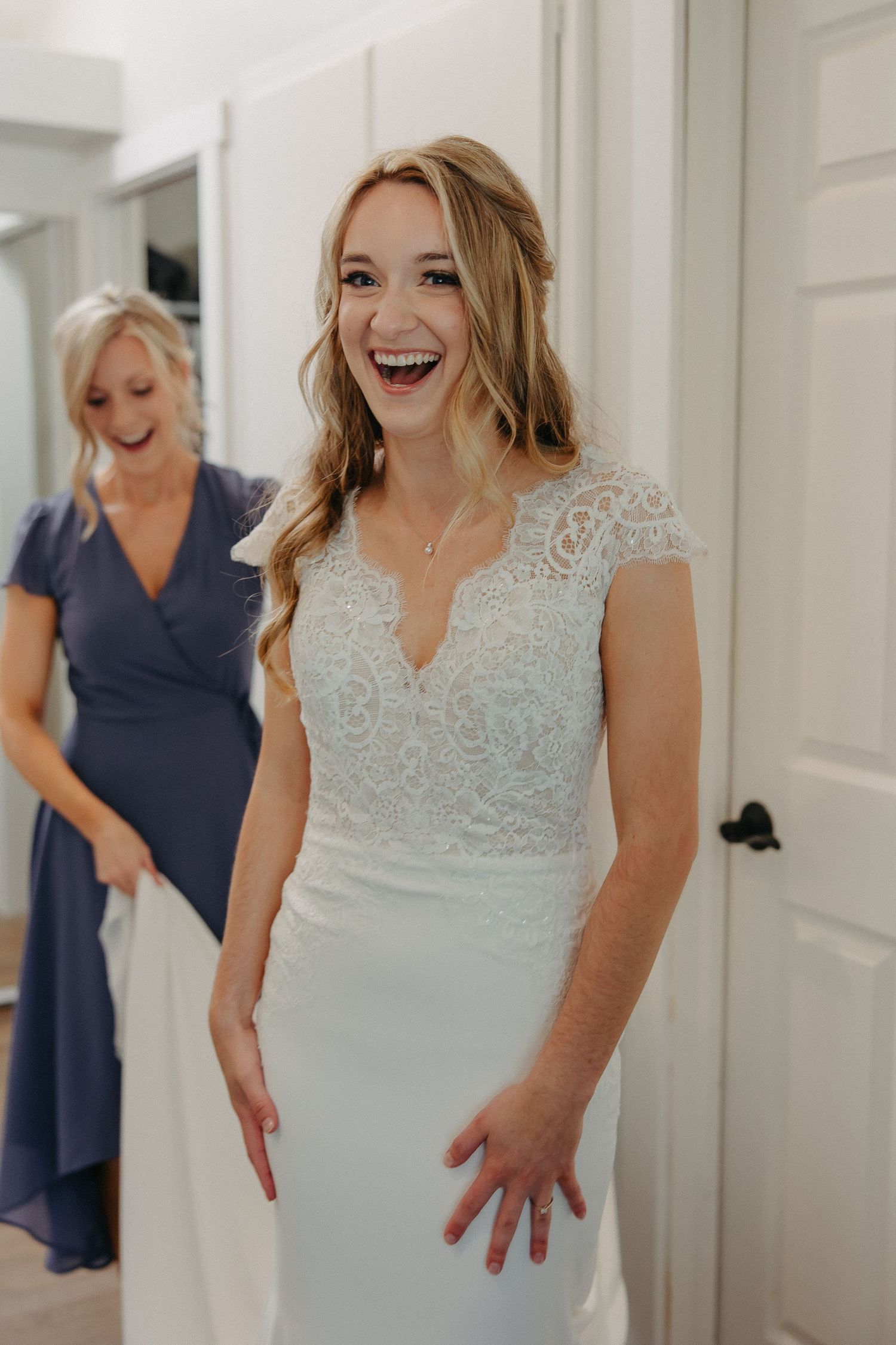 A joyful moment captured in a white dress during wedding preparations.