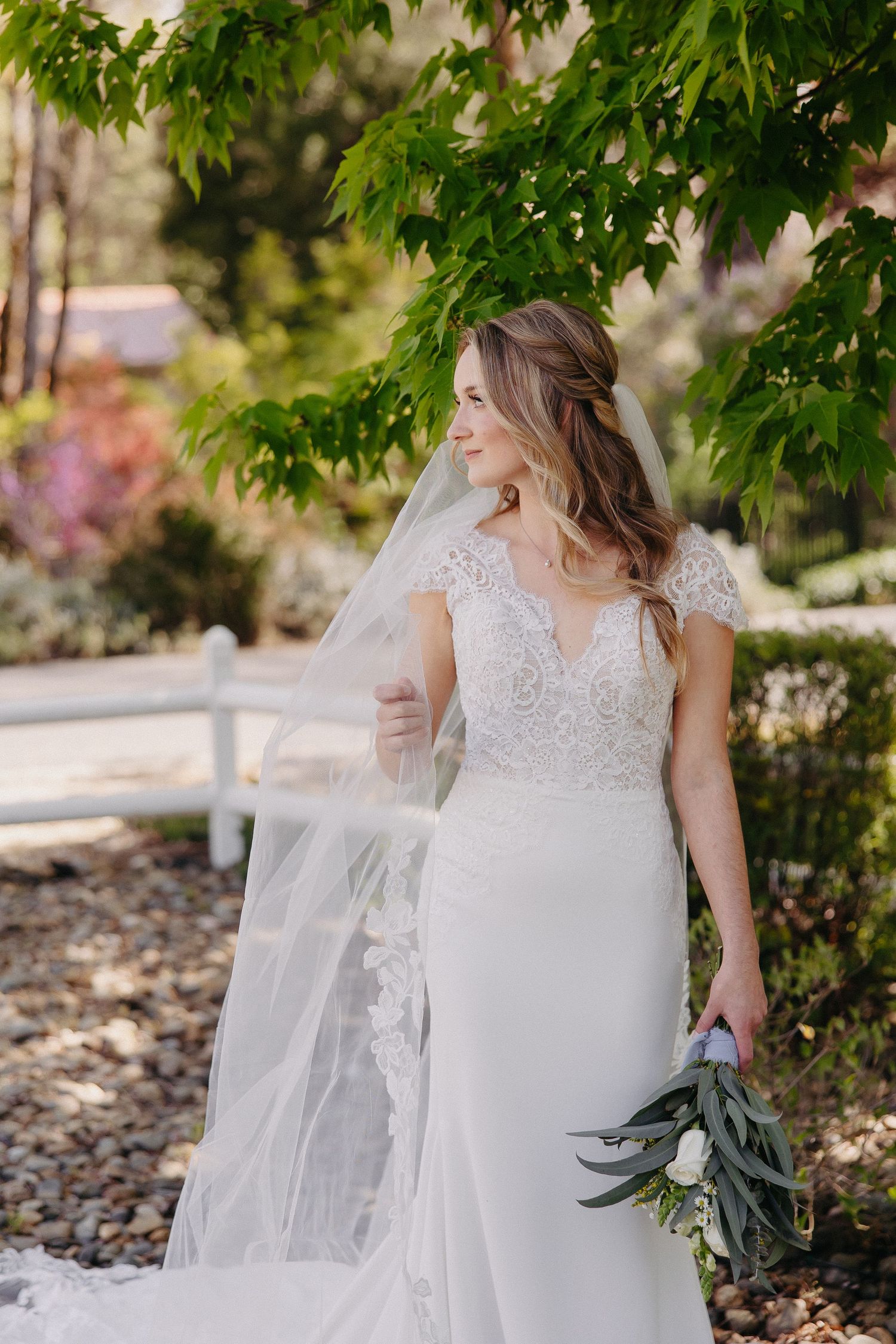 Spring garden bridal portrait with lace dress and eucalyptus bouquet.