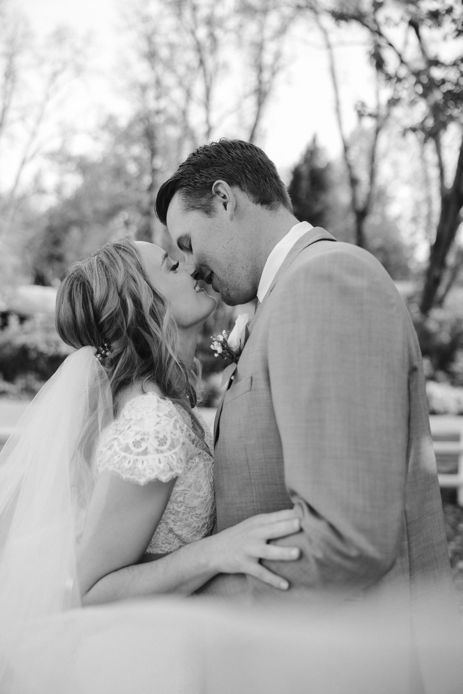 Black and white portrait capturing an intimate moment between newlyweds.