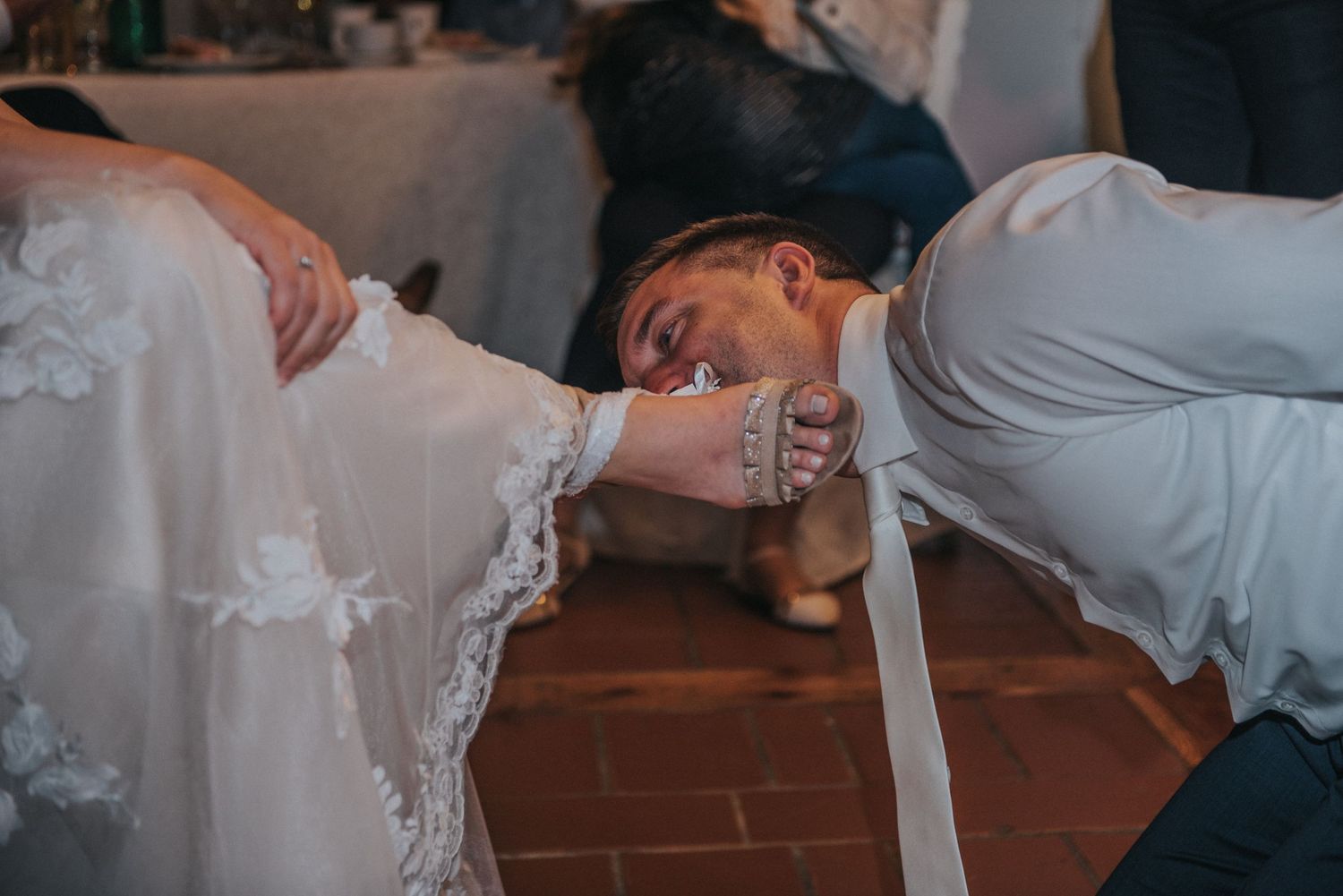 Creative wedding game with players drinking on the floor during reception.