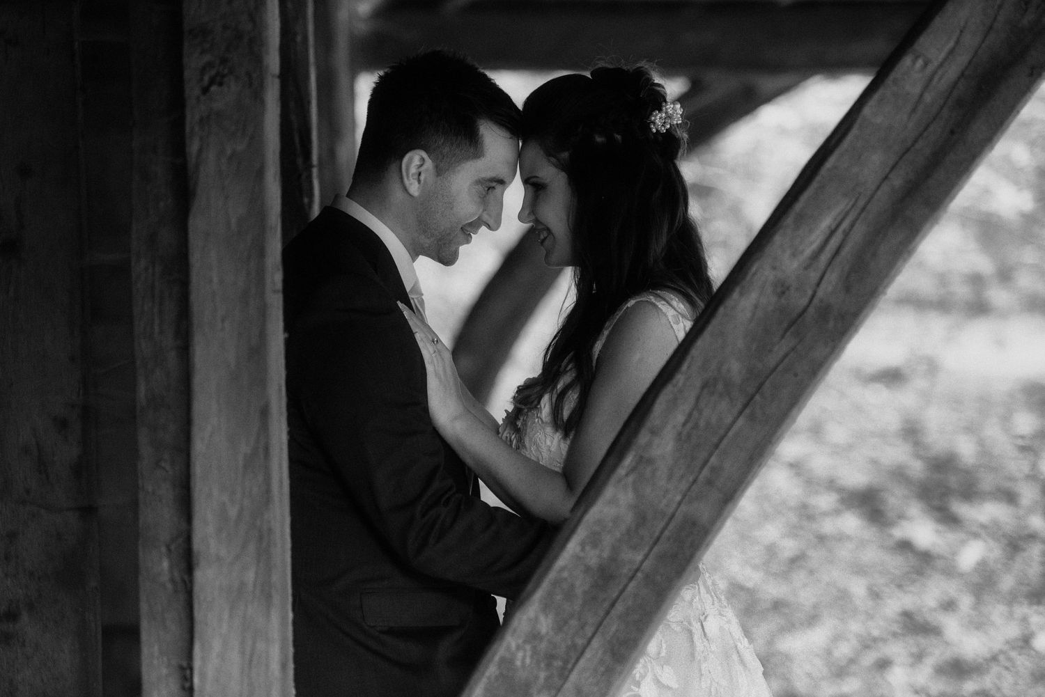 A tender moment captured in black and white within a rustic wooden frame.