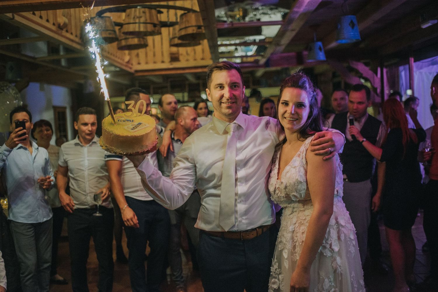 Wedding celebration on dance floor with celebratory champagne toast.