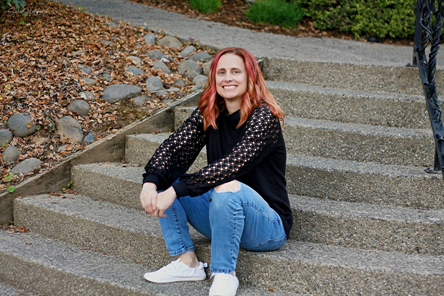 Casual outdoor portraits on concrete steps with brick wall backdrop.