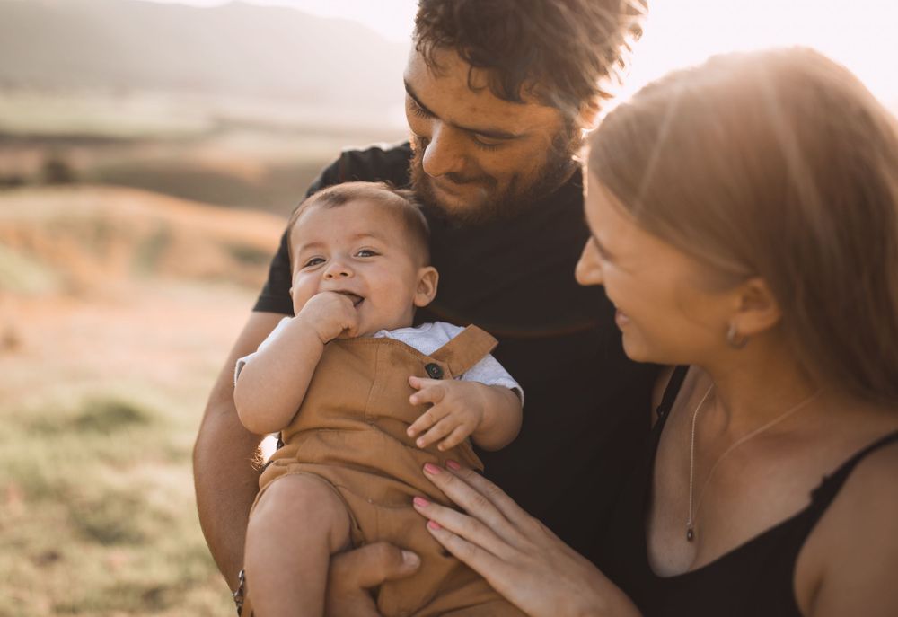 Sunset family photo session in golden light on rolling hills.