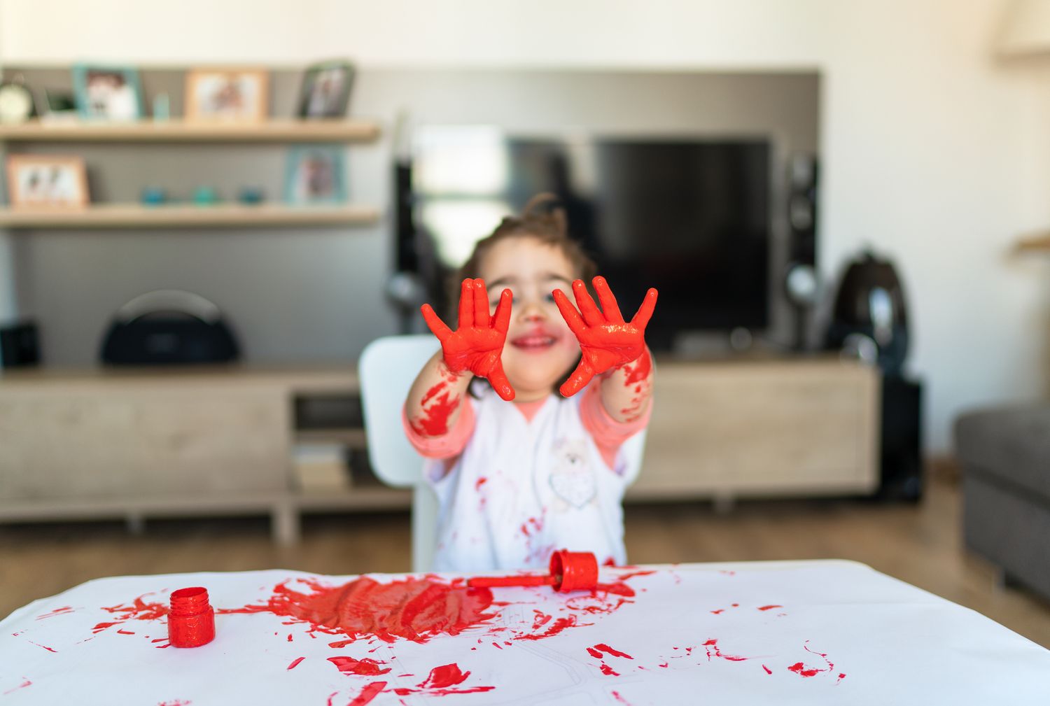 Kid with red paint on his hands - retail furniture protection plans
