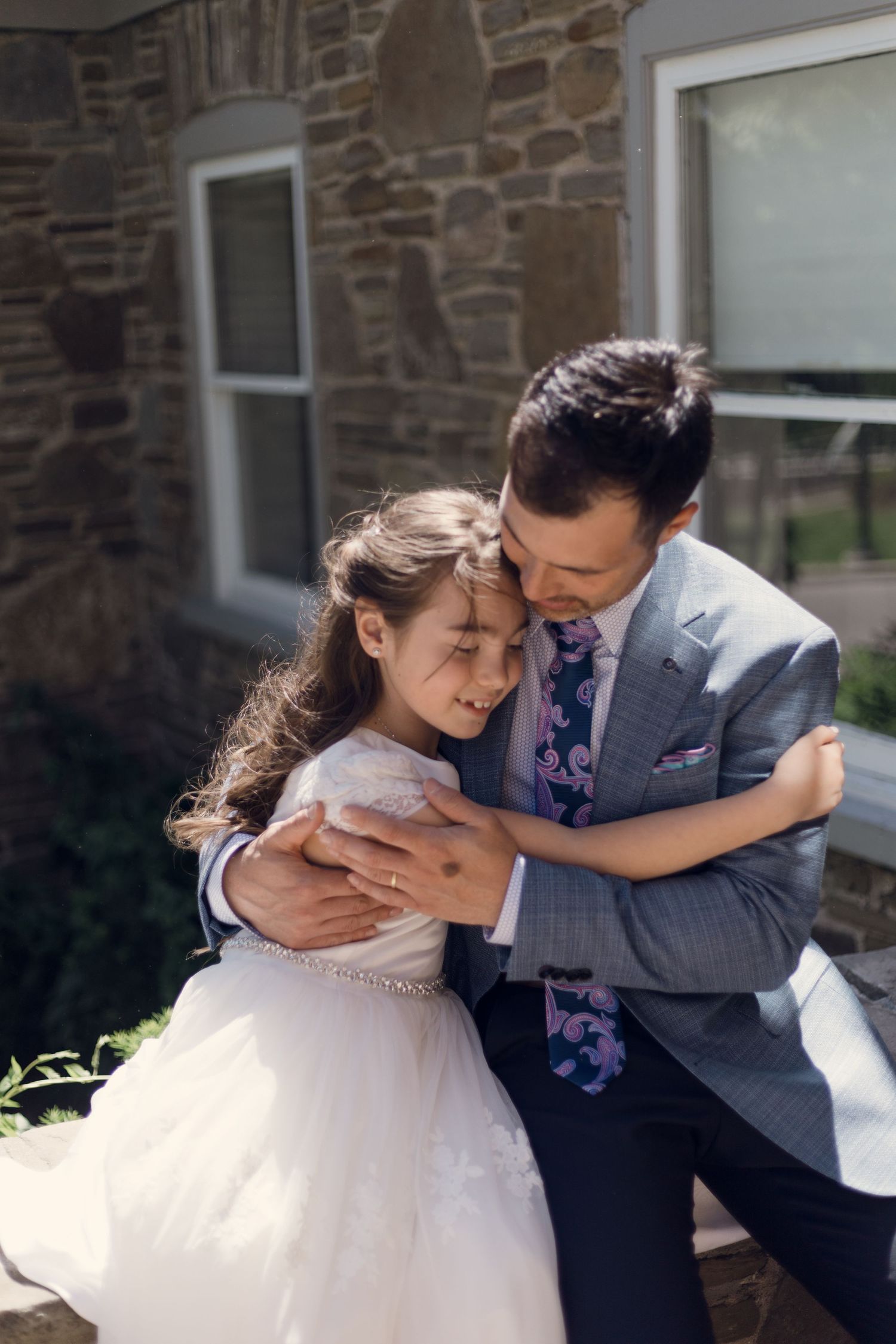 Father and daughter first communion hug