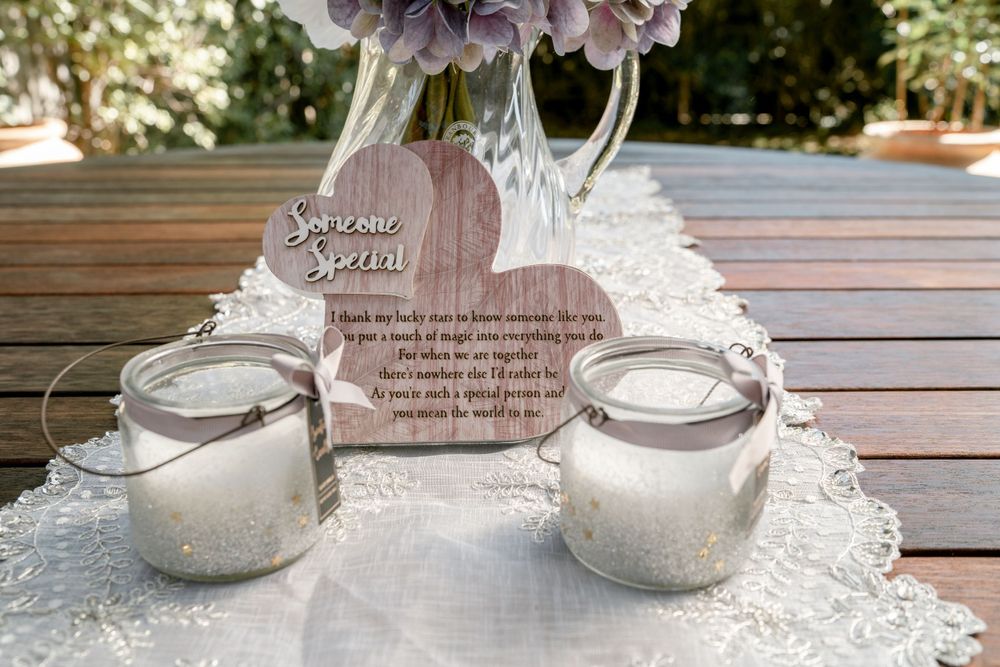 diy wedding memorial decoration with candles and white table runner on wooden table