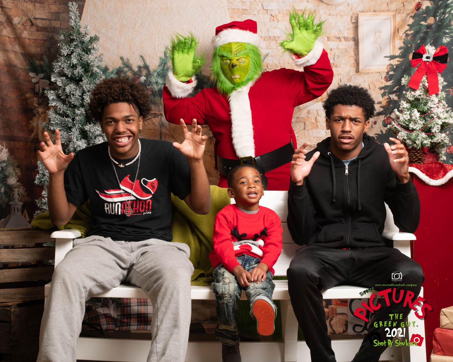 Holiday photo with Grinch character and three people on bench with Christmas decorations.