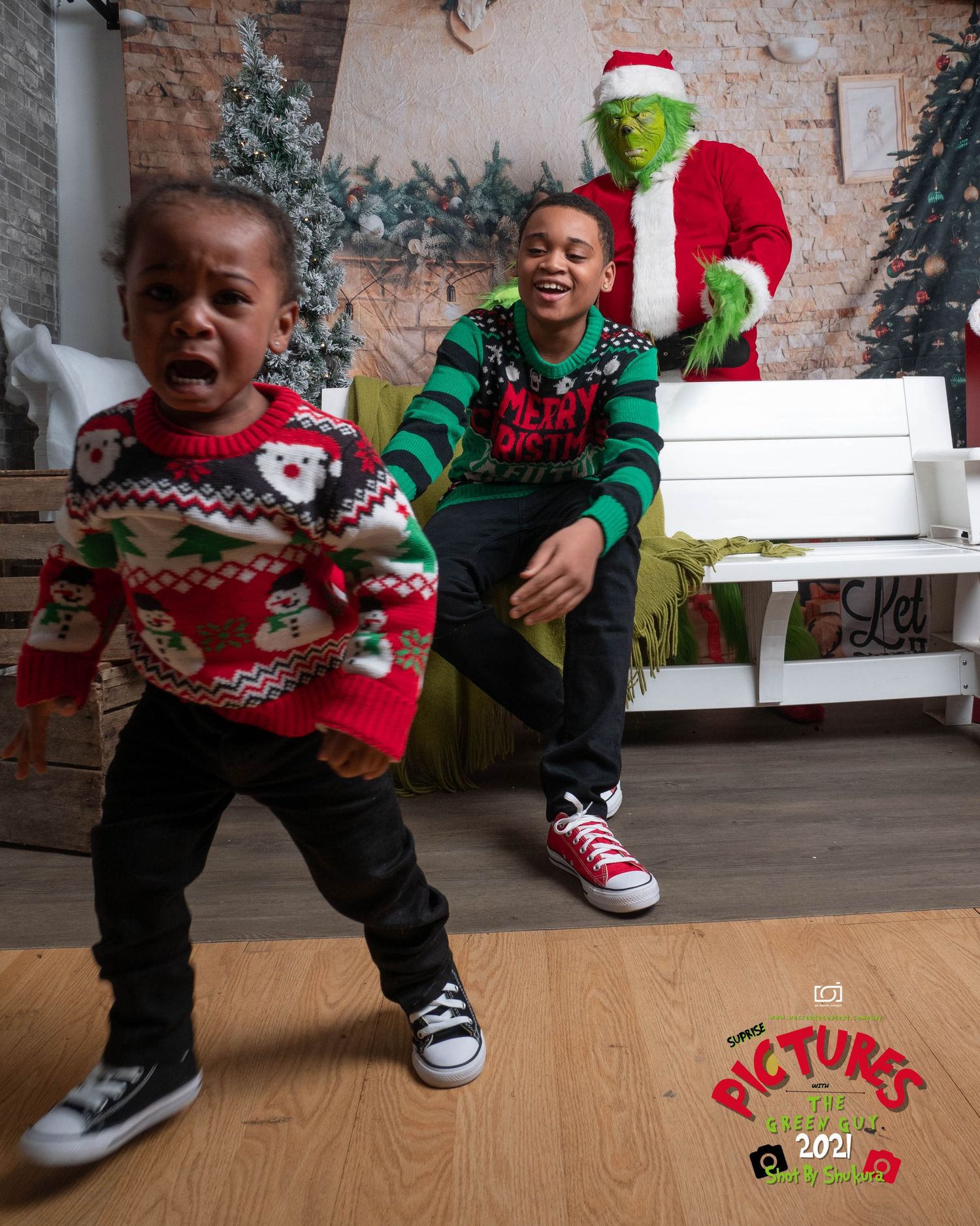 The Grinch in Santa costume surprises children in holiday sweaters during a festive photo shoot.
