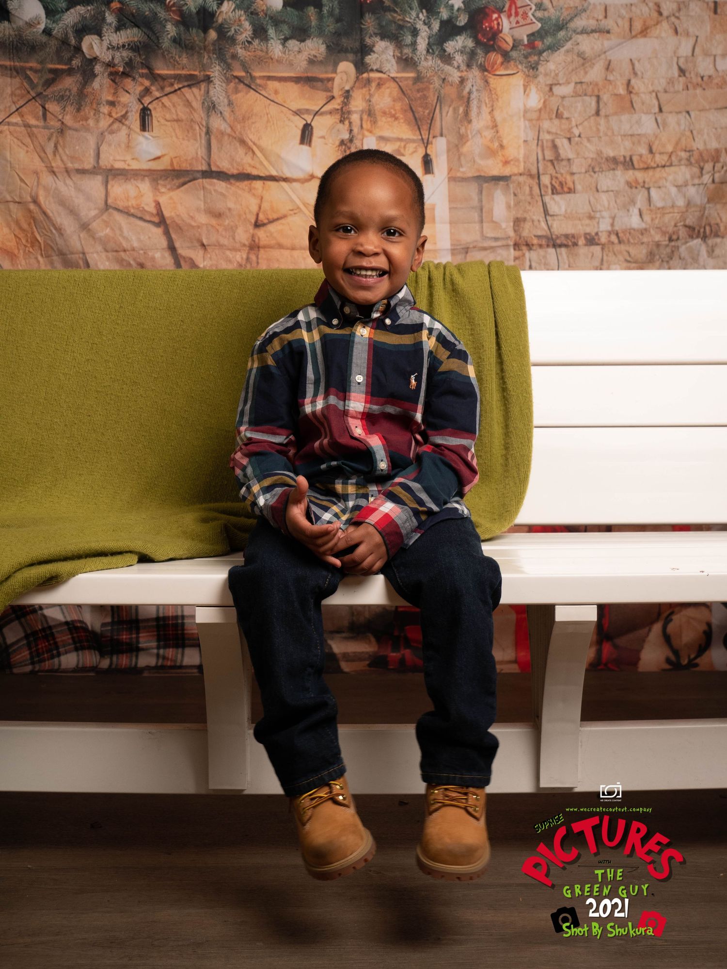A cheerful child sits on a lime green bench wearing a plaid fleece pullover and jeans with tan boots.