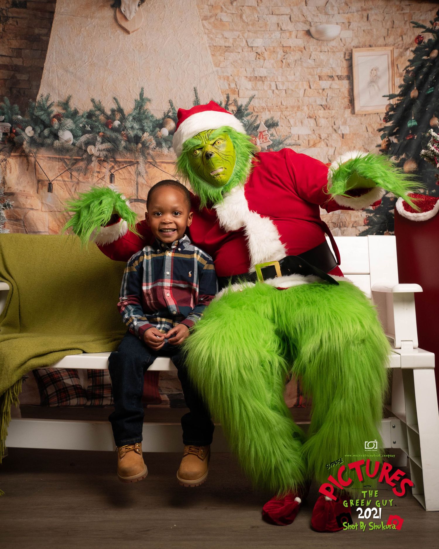 A child sits next to someone dressed as the Grinch in a Santa suit during a holiday photo session.