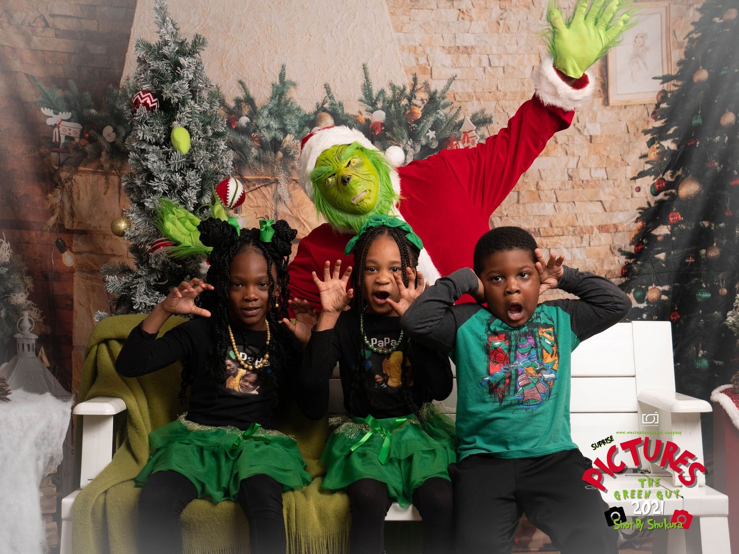 Children pose on a couch with a Grinch character during a festive holiday photo session with Christmas decorations.