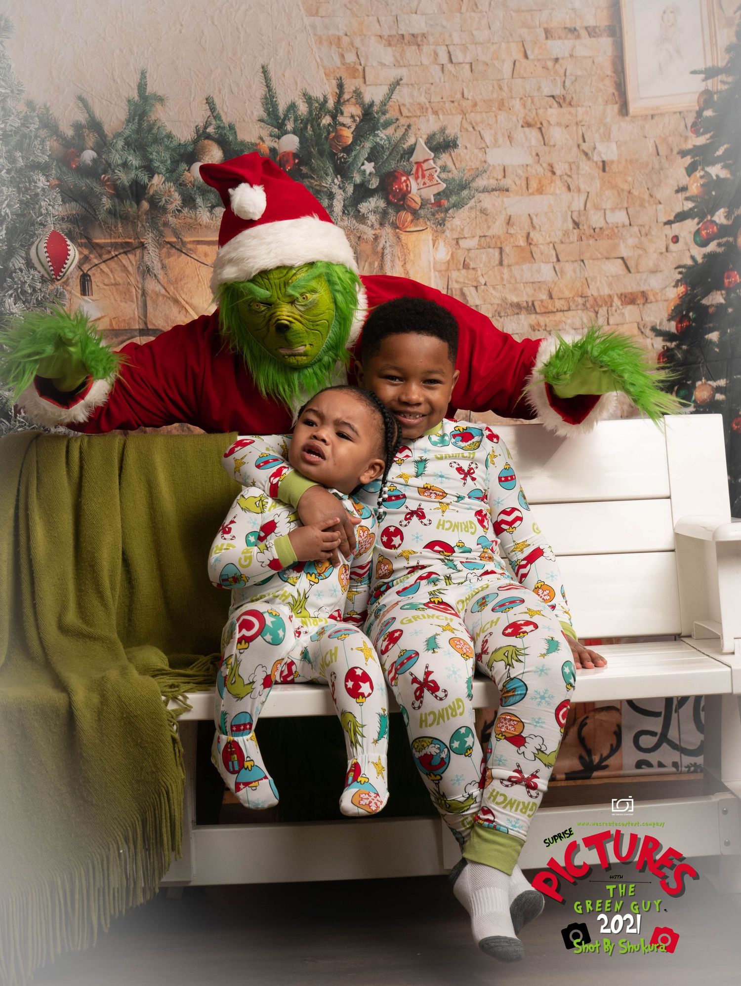 Holiday photo featuring someone in a green Grinch costume posing with others in matching Christmas pajamas on white steps.