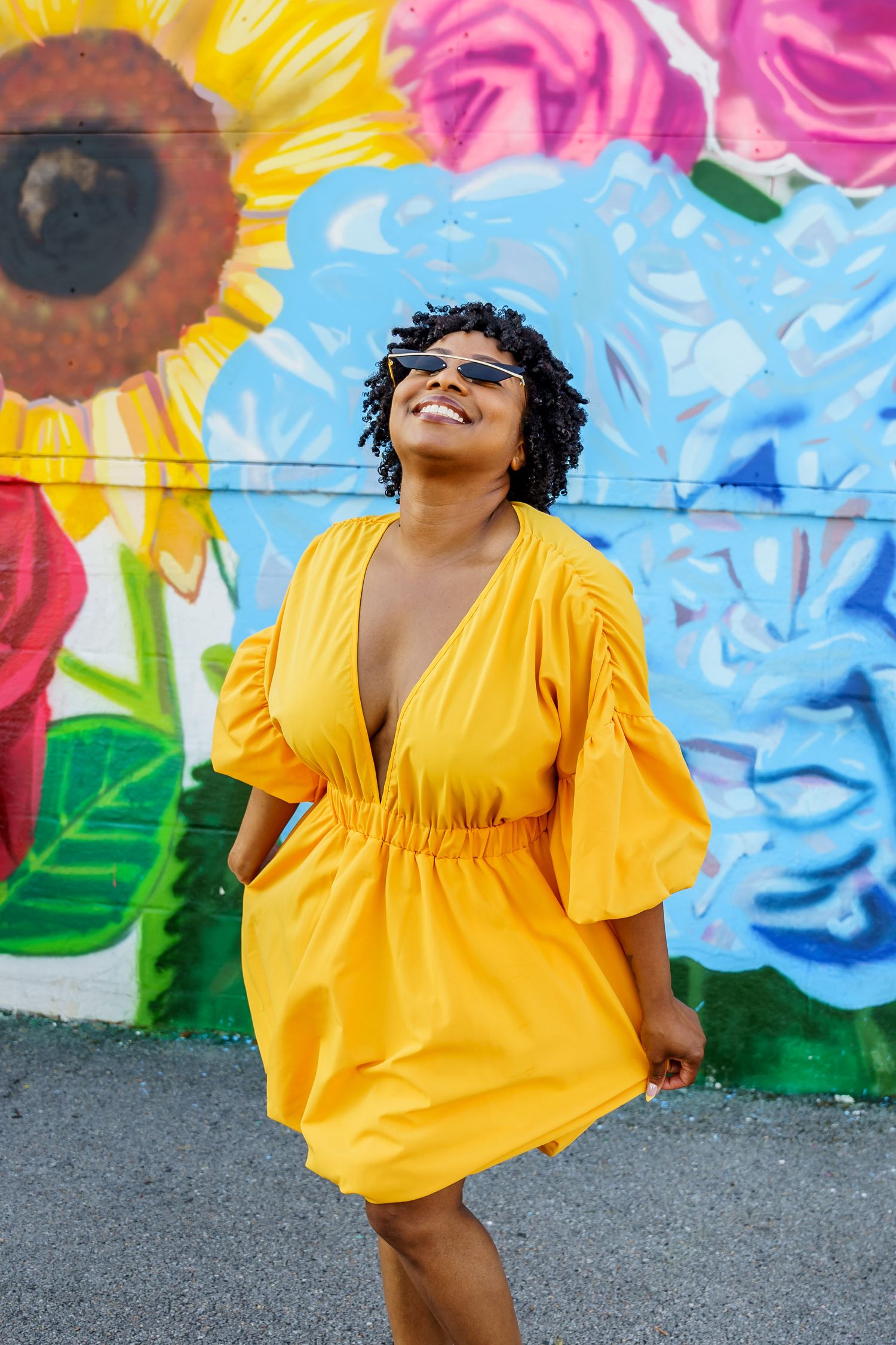 woman wearing yellow dress, smiling, in front of floral mural, downtown, birmingham, Norton's florist