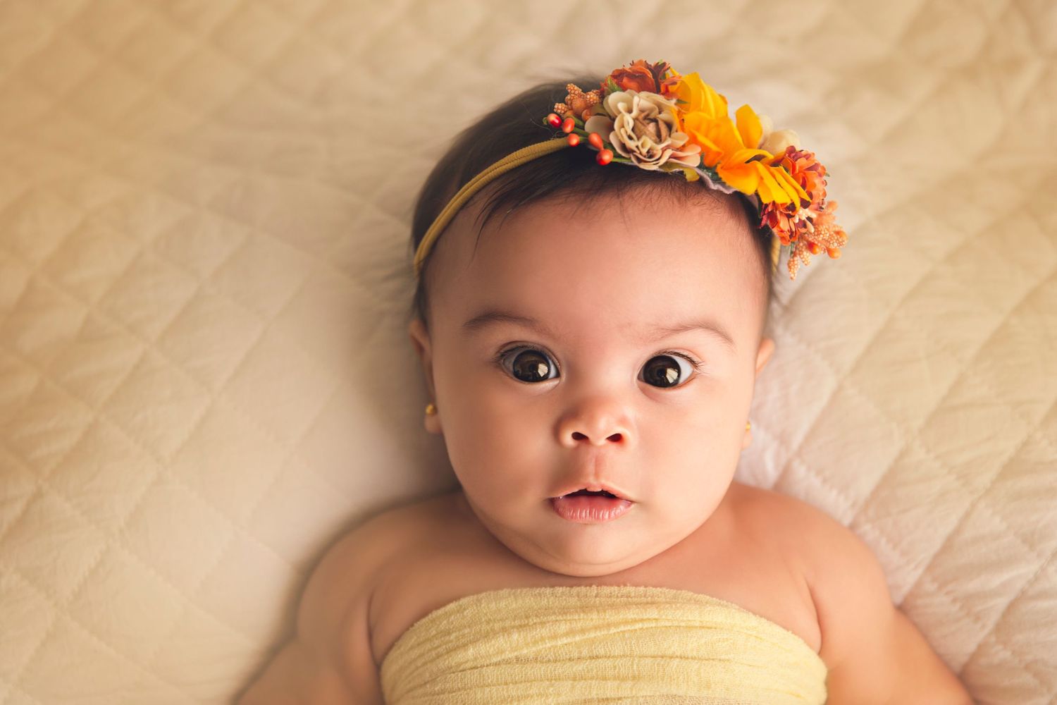 baby girl close up with floral headband yellow