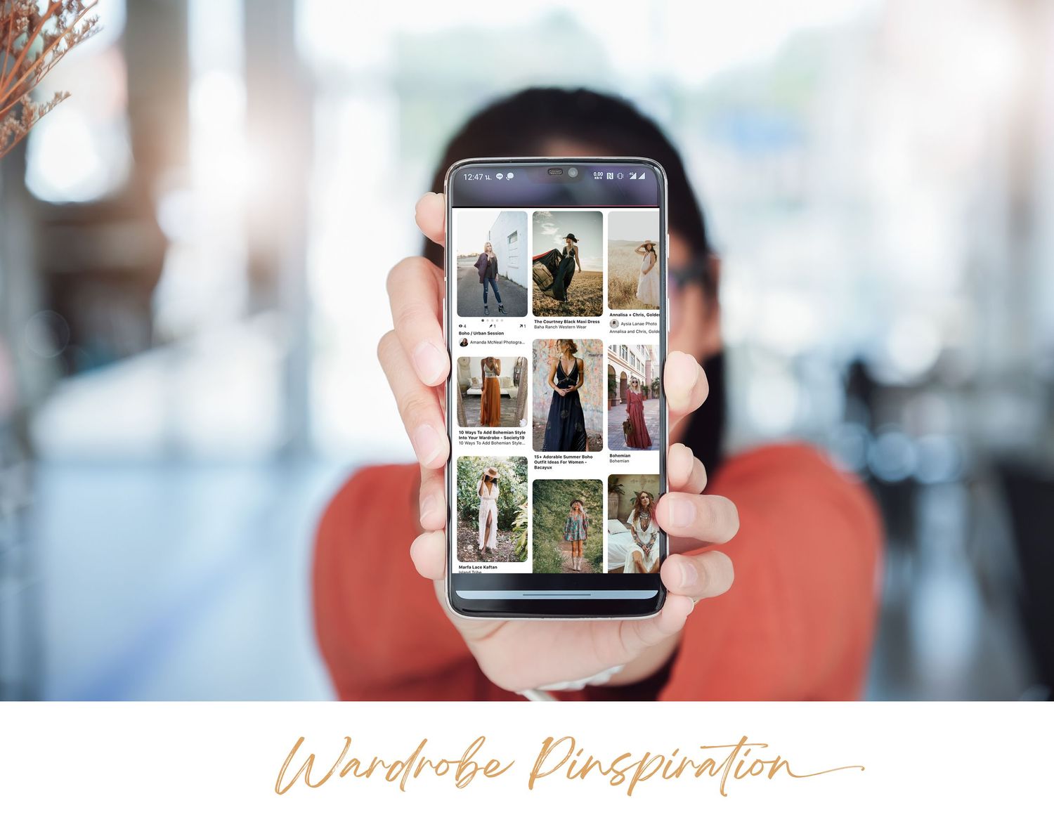 Hand holding smartphone displaying grid of photography portfolio images.