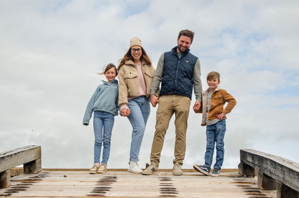 family of four posing at the top of a slipway