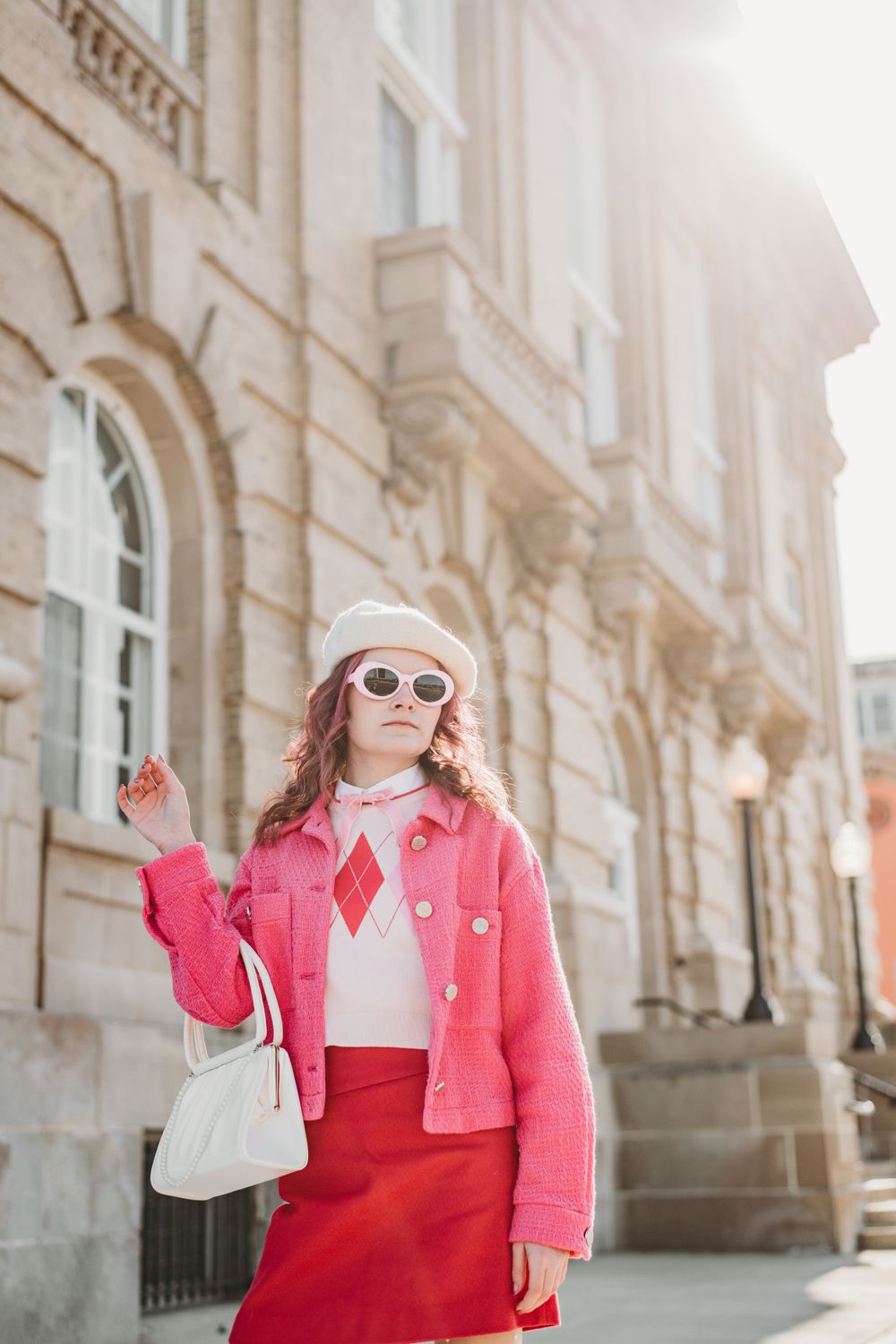 Stylish street fashion poses featuring bright pink jacket and white accessories.