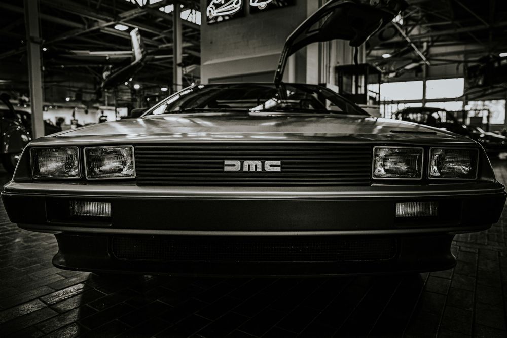 Front view of a classic DeLorean DMC car in black and white.