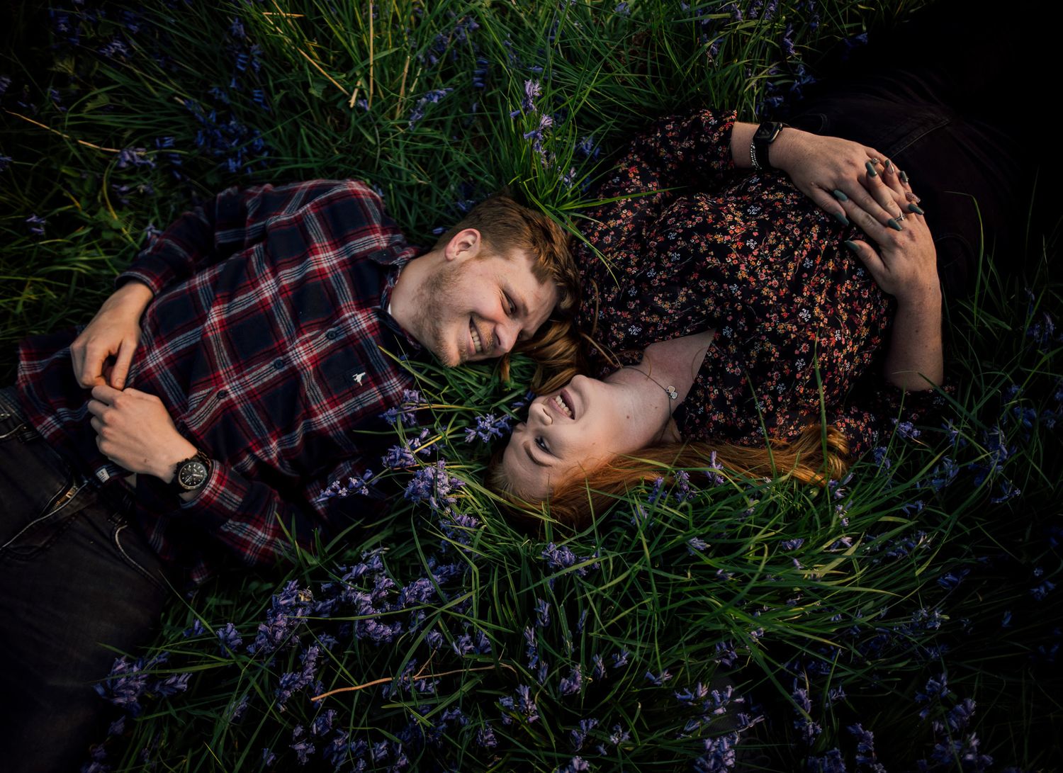 Artistic portrait session in dark field with wildflowers and natural lighting creating moody atmosphere. Worcestershire Wedding photographer