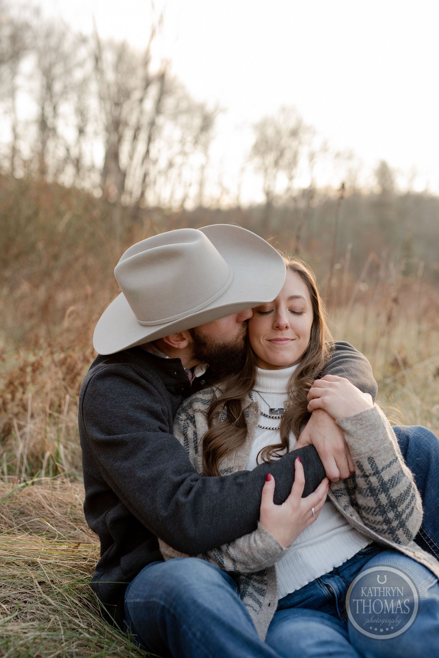 An intimate portrait of a couple sharing a tender moment in autumn scenery.