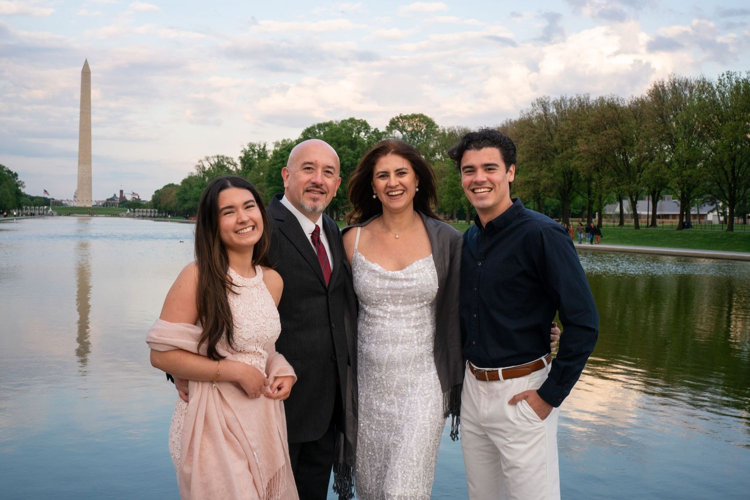 Group photos taken at sunset by the Washington Monument reflecting pool with the iconic monument in the background.