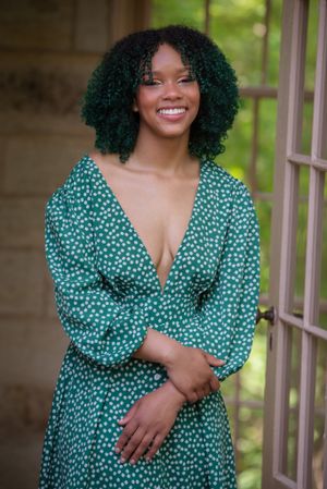 Portrait series showing person in green polka dot dress with curly hair outdoors.