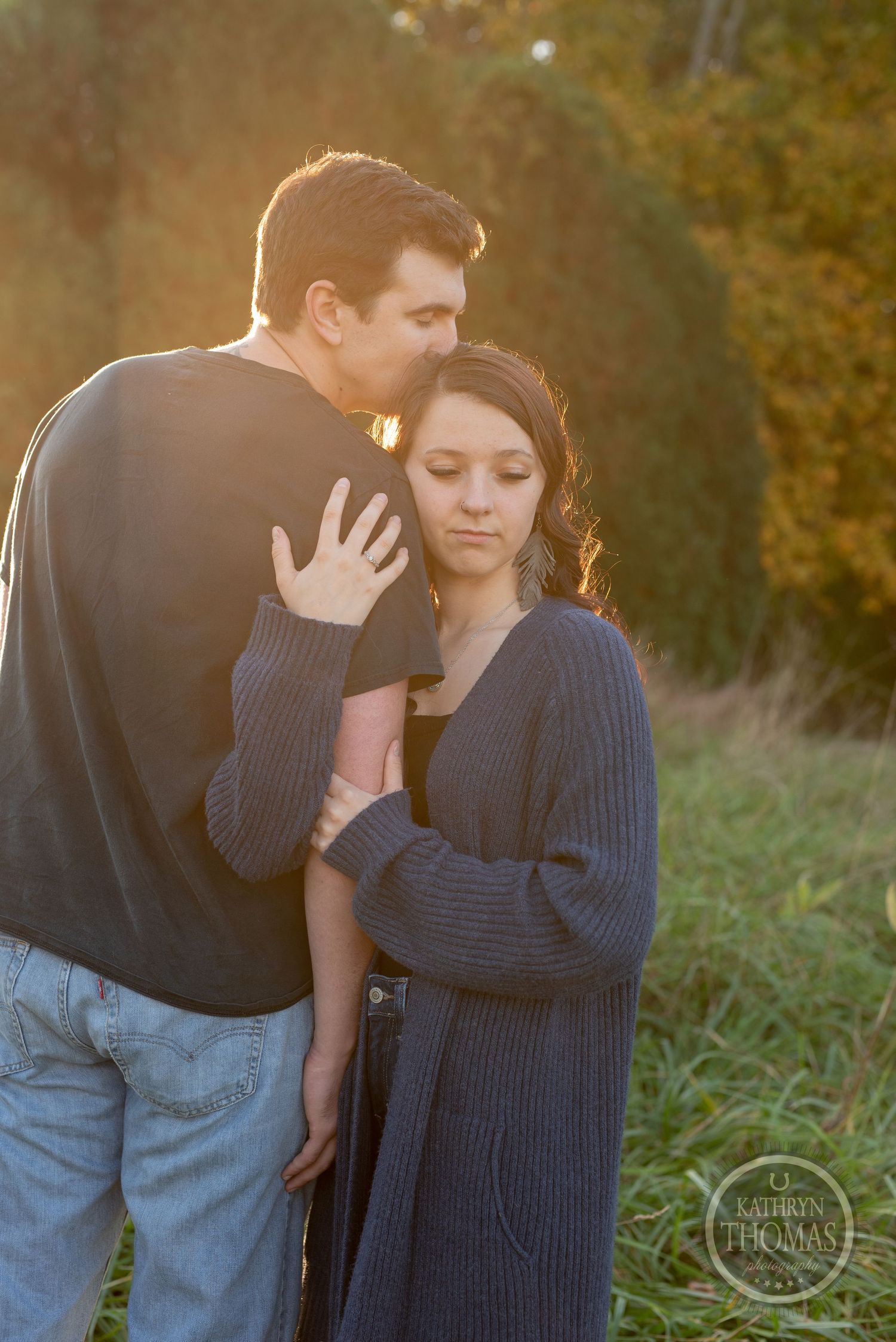 An intimate moment shared between a couple in casual wear during golden hour.