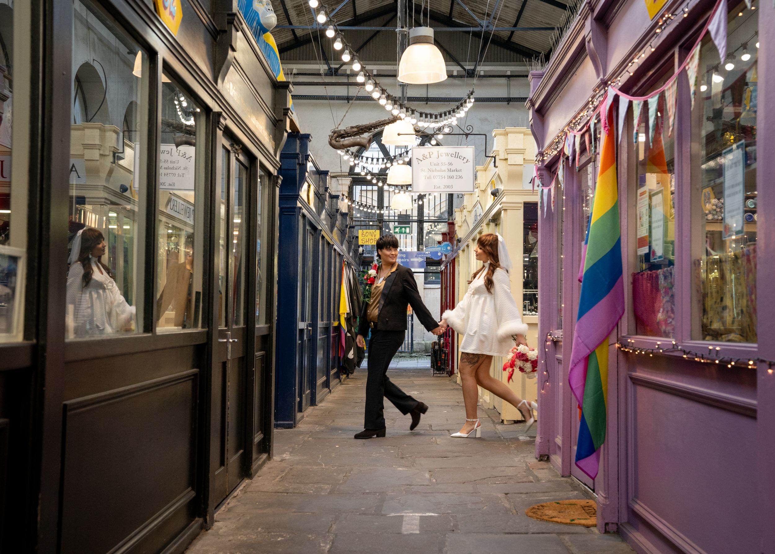 Shopping arcade interior with purple walls and string lights creating a cozy atmosphere.
