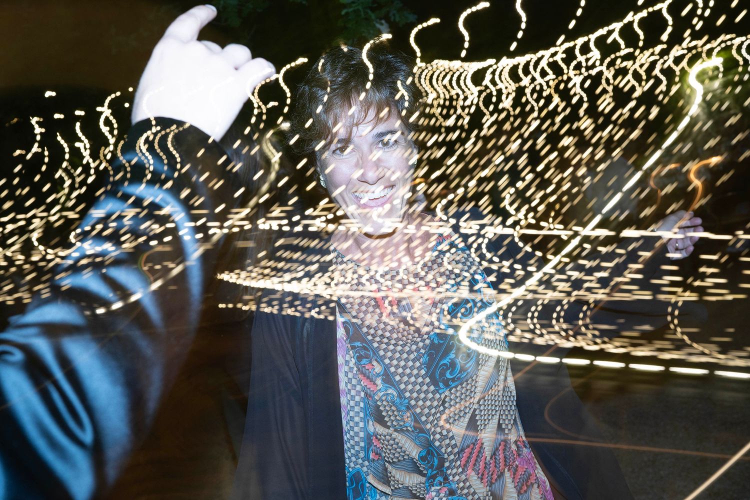Abstract light trails create patterns in a nighttime celebration photo.