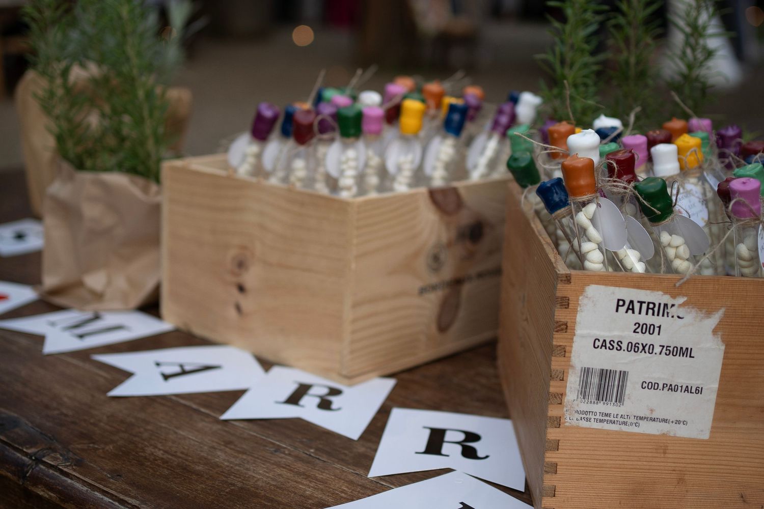 Wooden box filled with assorted drinks on ice with letter R signs displayed.