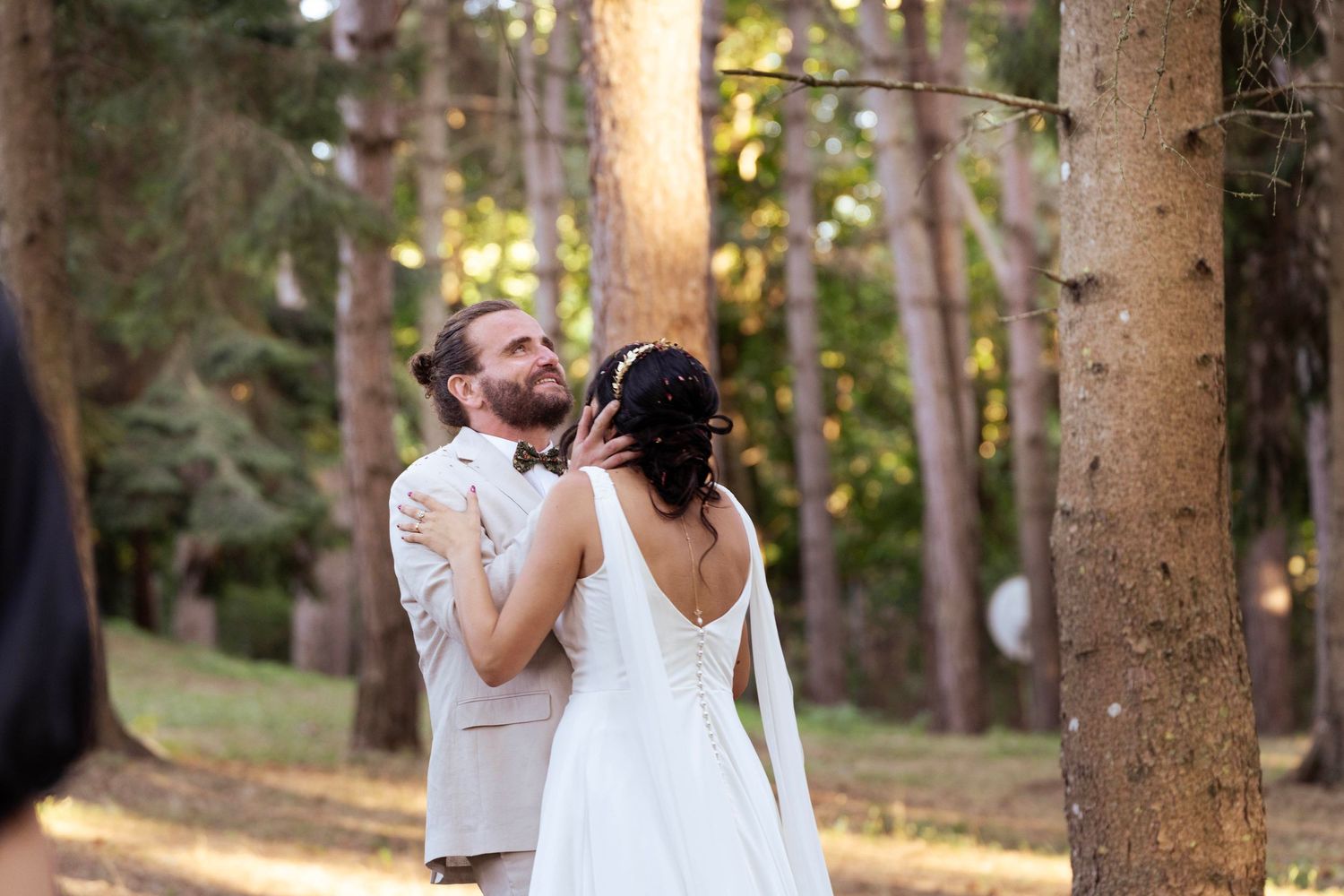 An intimate moment between newlyweds during their forest wedding ceremony.
