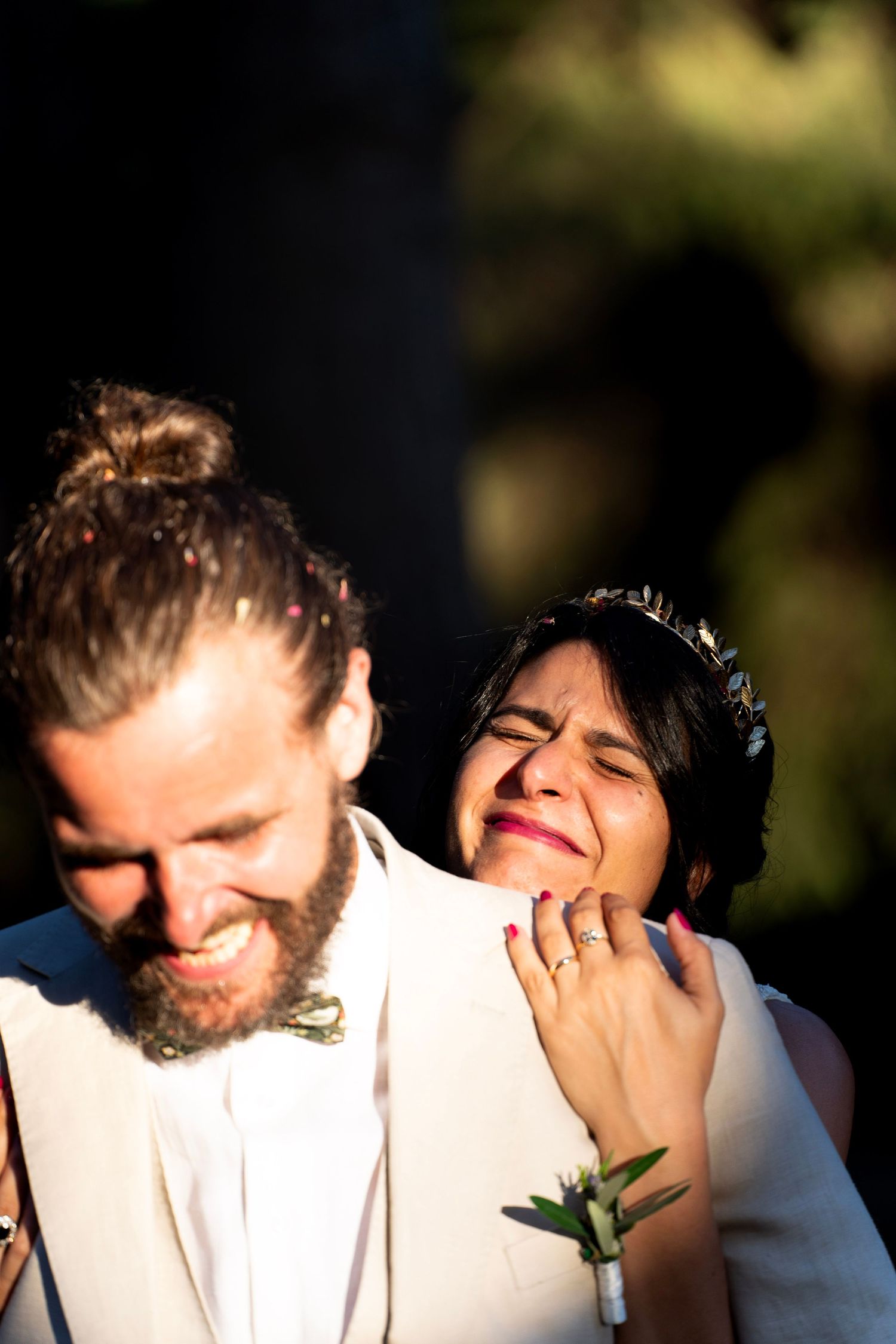 A candid moment of joy captured between newlyweds during their forest wedding.