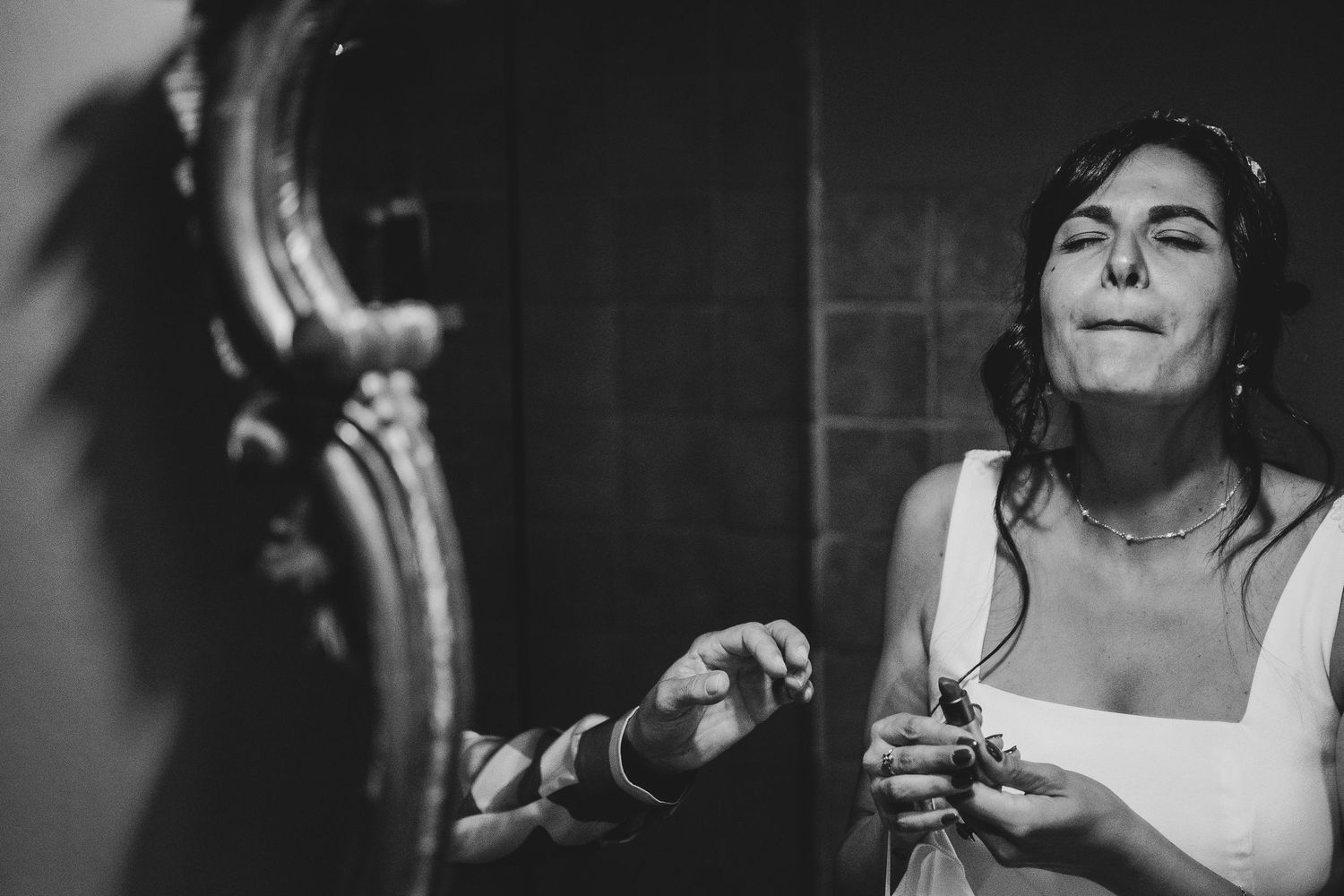 Black and white candid moment during wedding preparations.