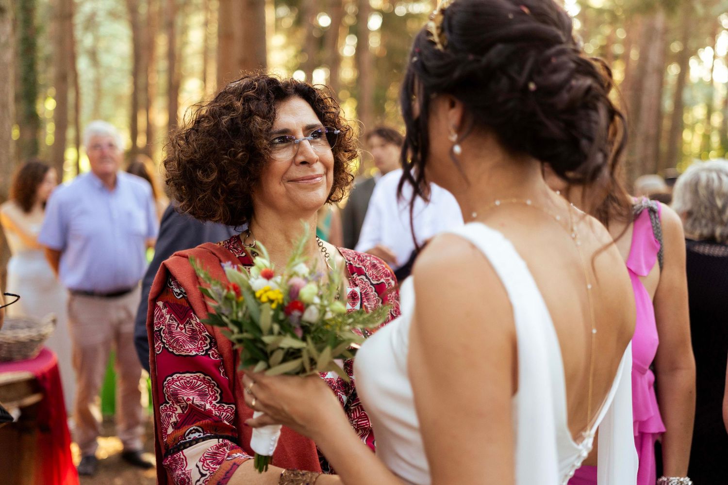 A tender moment shared during a forest wedding reception.