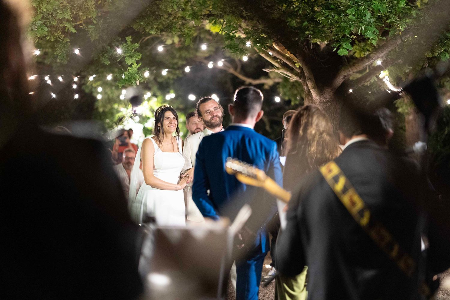 Nighttime outdoor celebration with string lights creating a magical atmosphere.