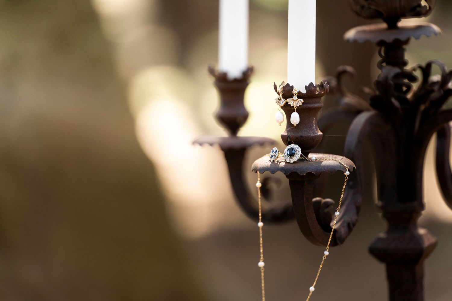 Ornate candelabra with white candles creating dramatic lighting and shadows.
