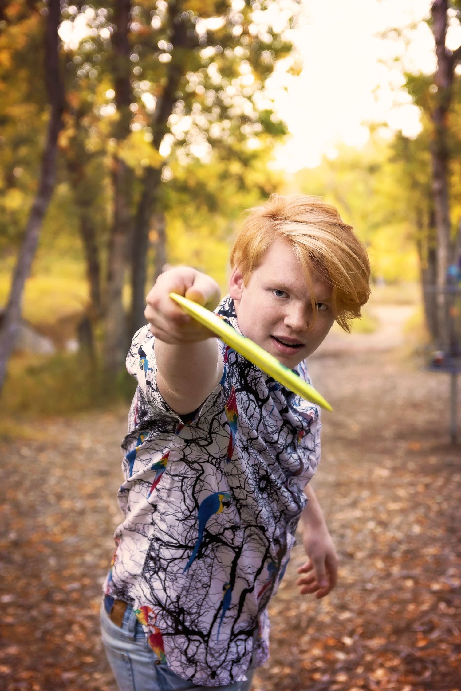 Teen with determined expression on autumn trail.
