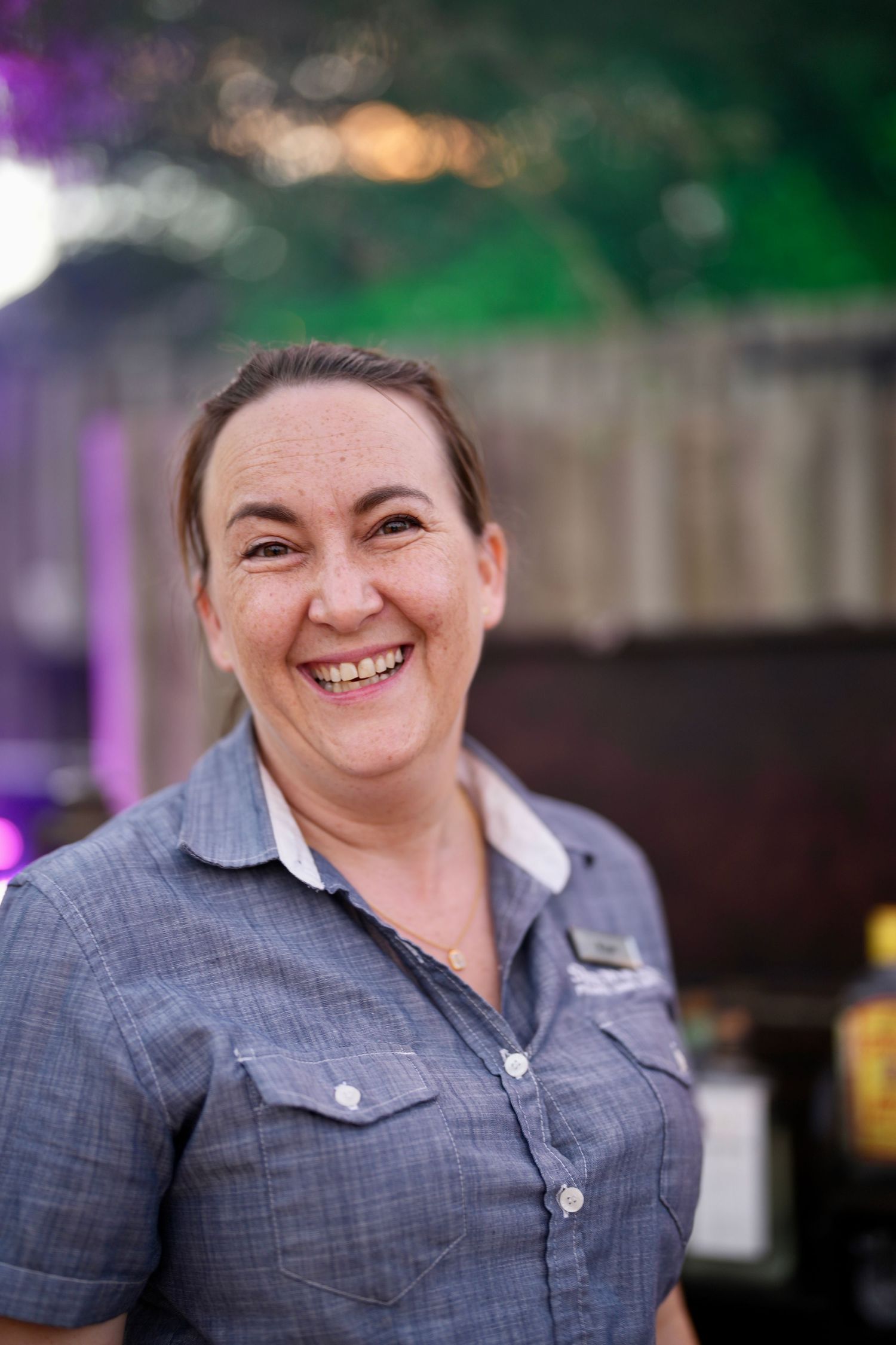 Staff member in grey uniform showing progressive expressions at work.